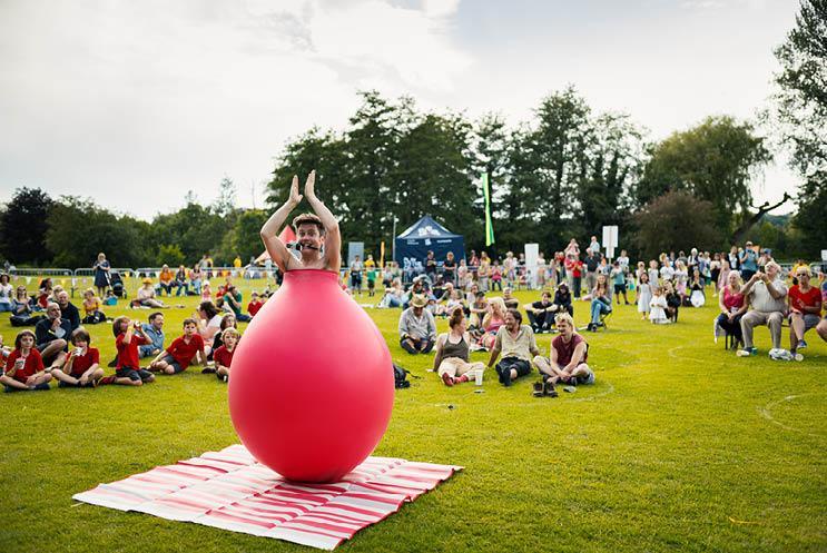 Man inside a balloon with crowd watching