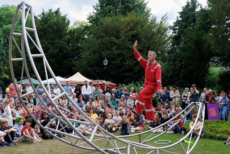 George Orange of his moon tightrope structure in front of a crowd.