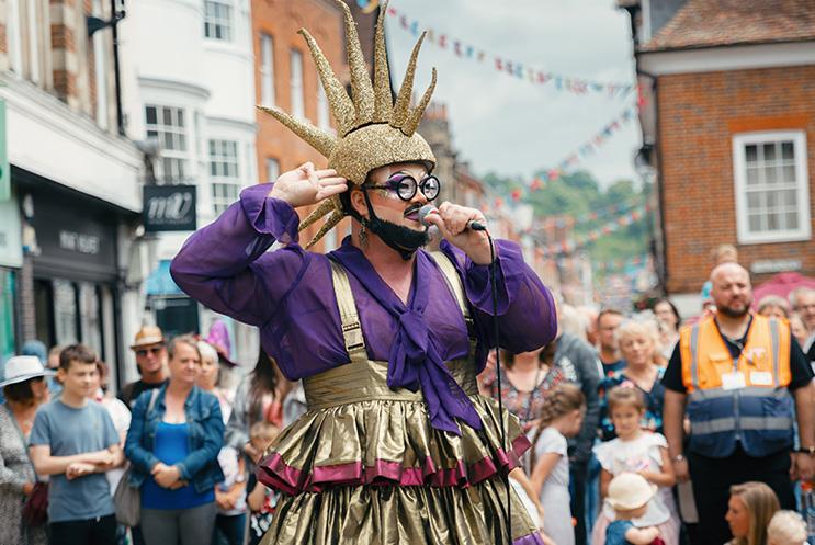 Colourful street performer with a mic