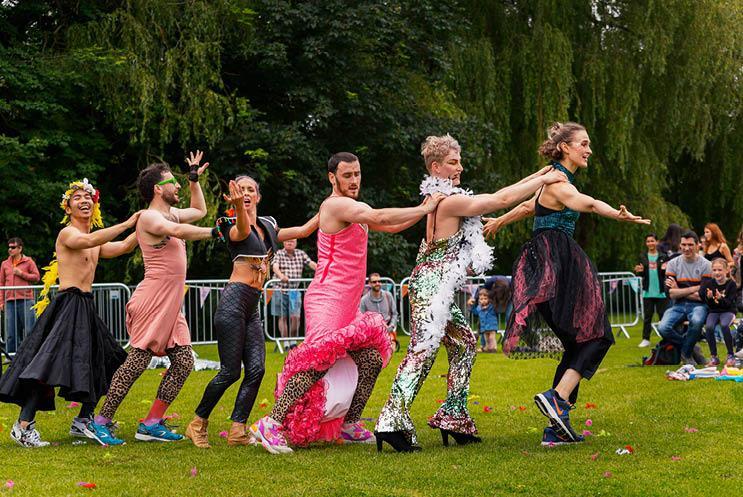 performers doing a conga line