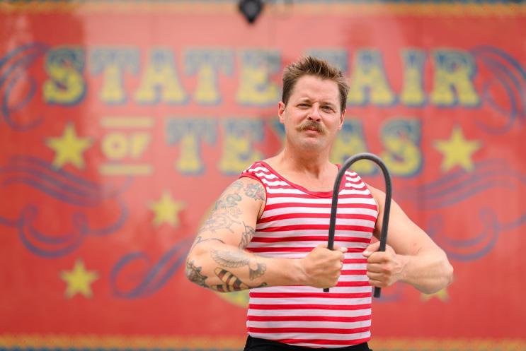 I performer being a strong man and bending metal