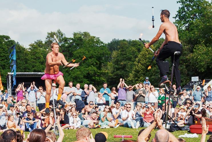 circus-style entertainers performing to a crowd