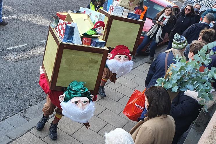 Christmas elves surprising shoppers