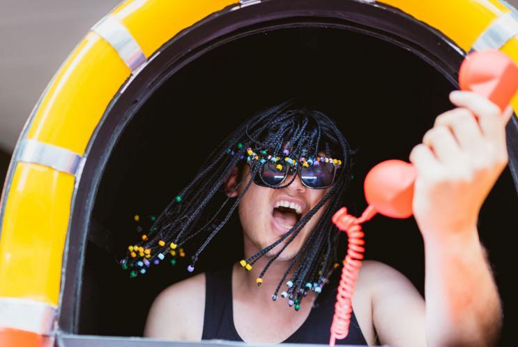 A Hat Fair performer yelling into a phone