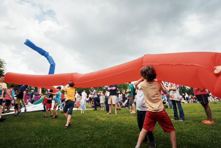 Children playing with a giant wind sculpture